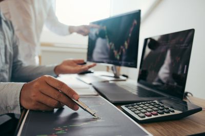 Investors analyzing the stock data, Capital Markets, Trading and Risk Management, Financial Services | DXC Technology